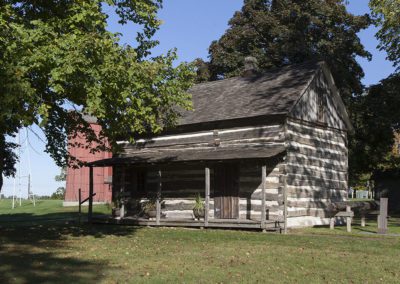Sheboygan County Museum Campus in summer, featuring log cabin and barn