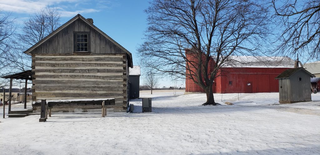 Barn and log cabin in winter