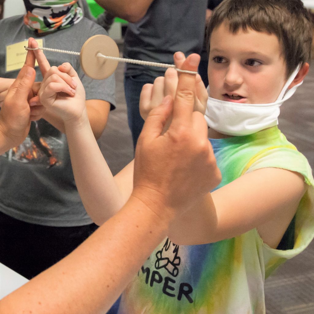 Full day ed buzz saw A Sheboygan elementary student learns how to spin a wooden "buzz saw" in the Full-Day Education Program at the Sheboygan History Museum