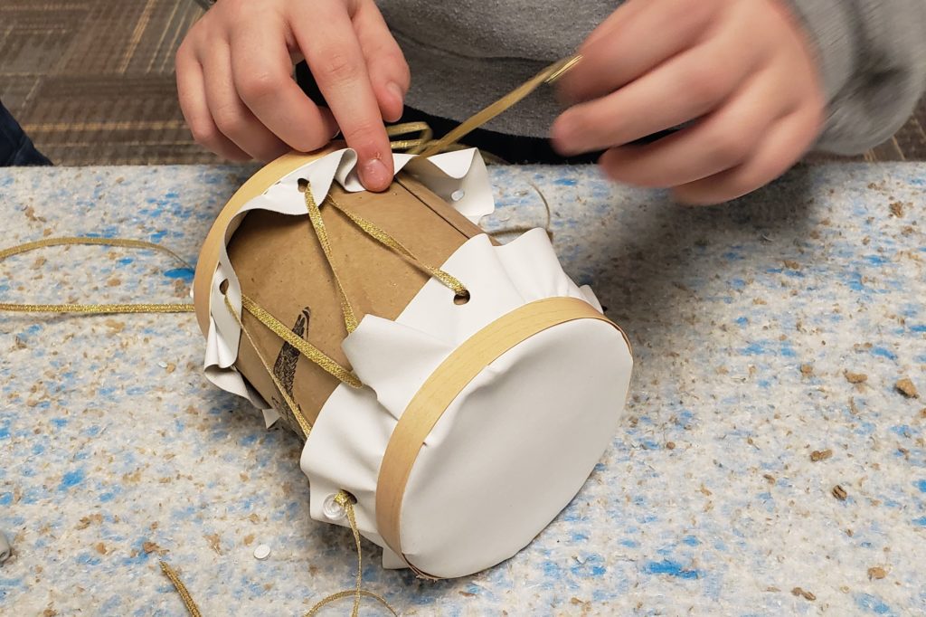 Lacing a drum in the Sheboygan History Museum's Full Day Education Program on the Civil War