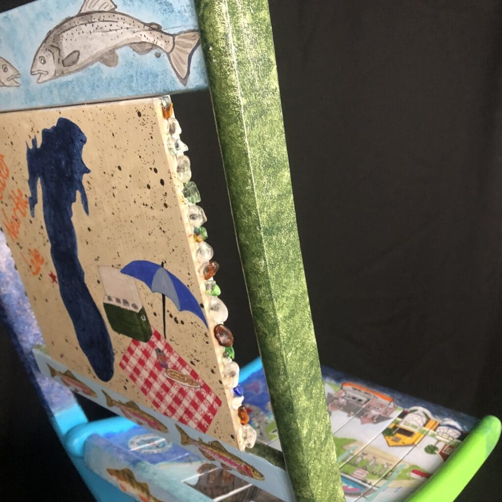 Artistically decorated chair featuring water related icons